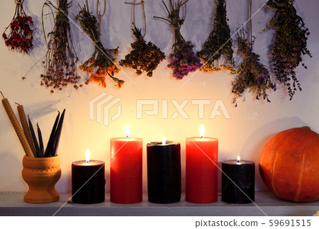 Still life with burning candles, dry herbs and pumpkin on witch table. Still life with burning candles, dry herbs and pumpkin on witch table. 59691515