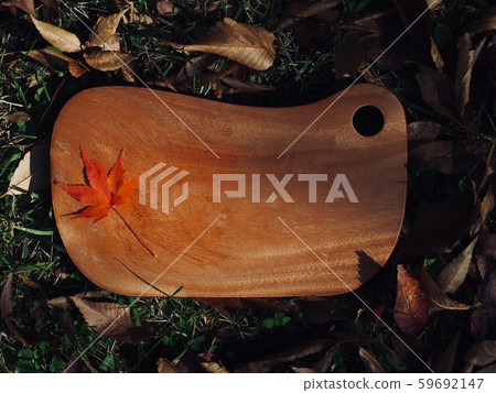 Wooden cutting board and maple leaves 59692147