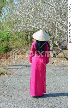 An Asian in traditional dress (Ao Dai) 59692247