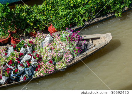 Wooden boats carrying flowers Wooden boats carrying flowers 59692420
