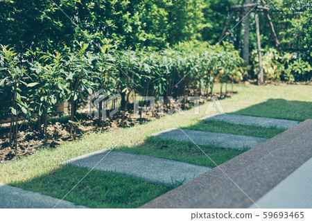 square stone block walkway laying on green grass decorated in backyard garden 59693465