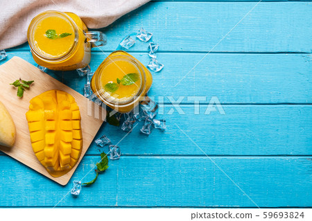 Refreshing mango smoothies in glass with ripe Refreshing mango smoothies in glass with ripe 59693824