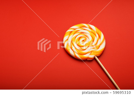 Colorful round Lollipop, on red background. 59695310