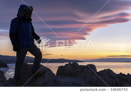 Happy man standing on cliff Happy man standing on cliff 59696745