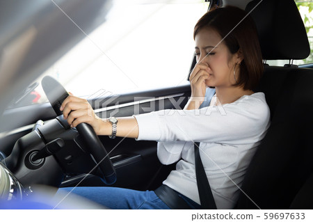 Young Asian woman hold her nose because of bad Young Asian woman hold her nose because of bad 59697633