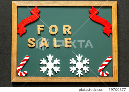 FOR SALE with red ribbon and red white candy cane and white snowflake on black background and blackboard 59700877