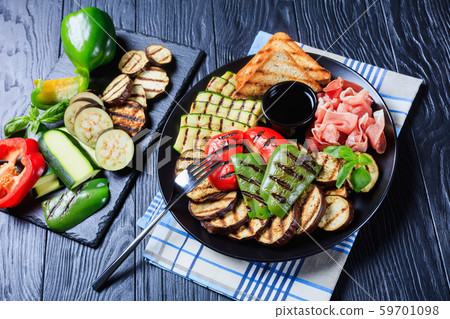 grilled vegetables, ham, toasted bread on a plate grilled vegetables, ham, toasted bread on a plate 59701098