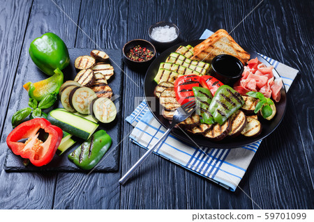 grilled vegetables, ham, toasted bread on a plate grilled vegetables, ham, toasted bread on a plate 59701099