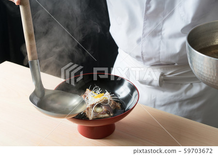 In front of the plate to soup the soup 59703672