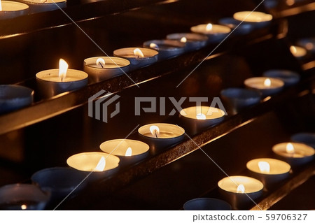Candles in a dark church 59706327