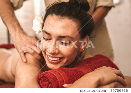 Alternative Medicine. Therapist healing woman laughing cheerful close-up doing abhyanga back massage 59706816