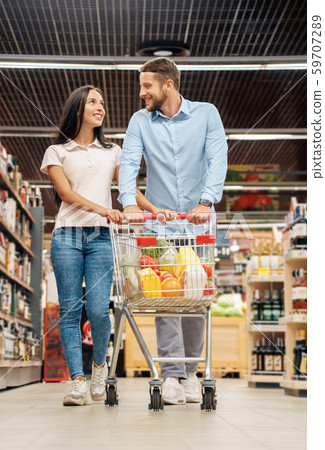 Young adult boyfriend and girlfriend shopping with trolley cart Young adult boyfriend and girlfriend shopping with trolley cart 59707289