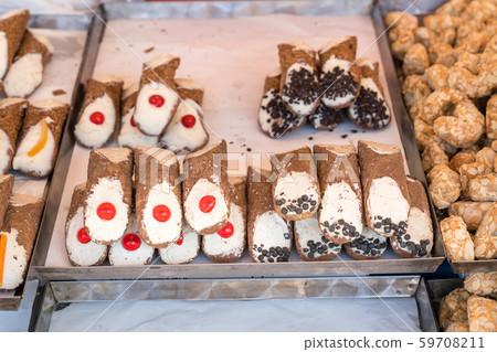 Freshly made sicilian Cannoli on a shelf Freshly made sicilian Cannoli on a shelf 59708211