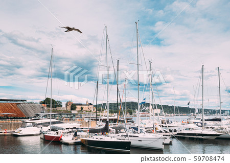Oslo, Norway. Moored Boats And Yachts At Aker Brygge District. Seascape Of Harbour And Quays In Oslo, Norway. Moored Boats And Yachts At Aker Brygge District. Seascape Of Harbour And Quays In 59708474