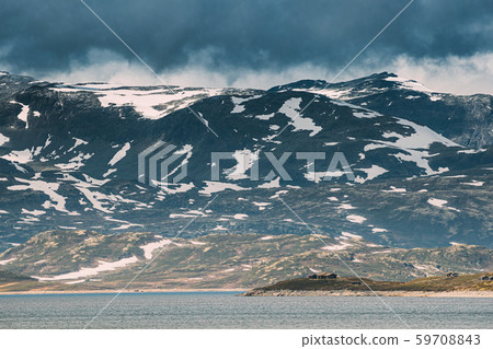 Oppland, Tyin Lake, Norway. Stones On Coast Of Beautiful Lake Tyin In Summer Cloudy Day. Norwegian Oppland, Tyin Lake, Norway. Stones On Coast Of Beautiful Lake Tyin In Summer Cloudy Day. Norwegian 59708843