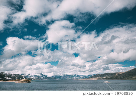 Oppland, Tyin Lake, Norway. Stones On Coast Of Beautiful Lake Tyin In Summer Cloudy Day. Norwegian Oppland, Tyin Lake, Norway. Stones On Coast Of Beautiful Lake Tyin In Summer Cloudy Day. Norwegian 59708850