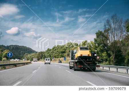 Car Service Transportation Concept. Tow Truck Transporting Retro Car On Motorway Freeway Highway 59709079