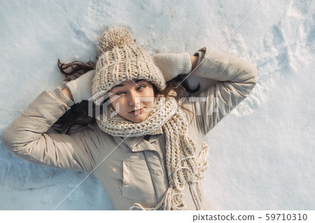 Funny Woman Lying on the Snow 59710310