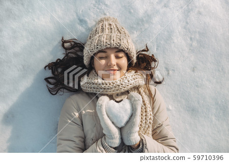 Snow Heart in Hands of a Woman Snow Heart in Hands of a Woman 59710396