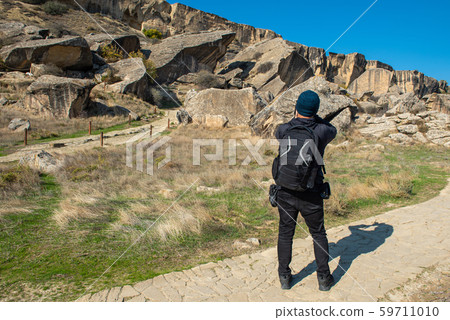 Asian photographer man take photo of rock cave in Asian photographer man take photo of rock cave in 59711010