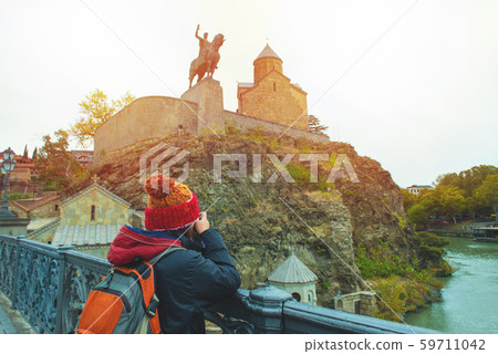 Asian travel backpacker lady in winter suit use 59711042