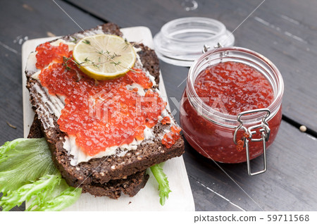 Red caviar sandwich with butter and salad leaves 59711568