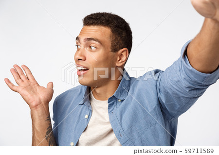 Handsome male in casual outfit record vlog from christmas travel, hold camera one stretch hand Handsome male in casual outfit record vlog from christmas travel, hold camera one stretch hand 59711589