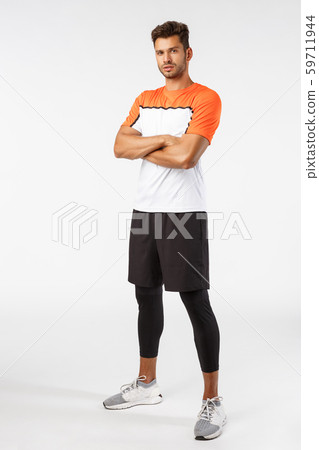 Confidence, sport and fitness concept. Vertical shot good-looking bearded handsome young sportsman Confidence, sport and fitness concept. Vertical shot good-looking bearded handsome young sportsman 59711944