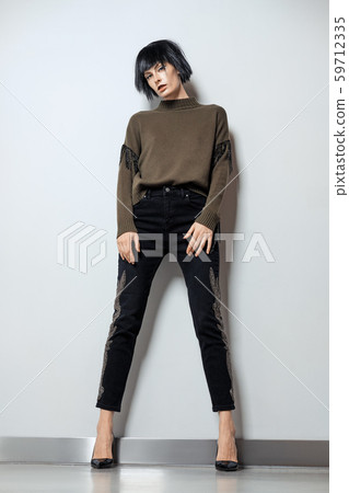 Fashion model in black wig, pullover with fringe Fashion model in black wig, pullover with fringe 59712335