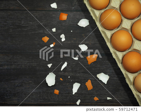 Eggs in the cardboard on the wooden floor 59712471