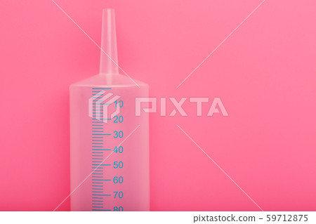 Medical syringe on cyanide, pink background 59712875