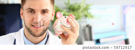 Smiling doc holding thrift-box Smiling doc holding thrift-box 59712917