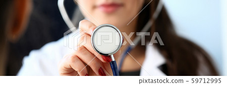 Beautiful smiling female doctor hold in arm Beautiful smiling female doctor hold in arm 59712995