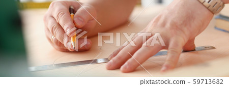 Arms of worker making structure plan on scaled paper closeup Arms of worker making structure plan on scaled paper closeup 59713682