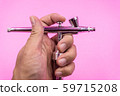 Airbrush double action spray work for hobby, makeup, art work, cake decoration, body paint in male hand pink background 59715208
