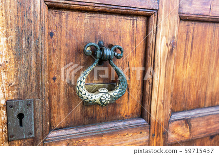 Wooden door with doorknob made of bronze 59715437
