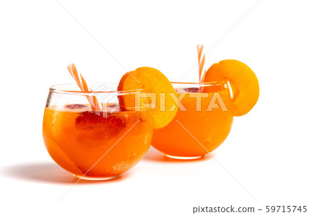 Peach juice in a glass on white background Peach juice in a glass on white background 59715745
