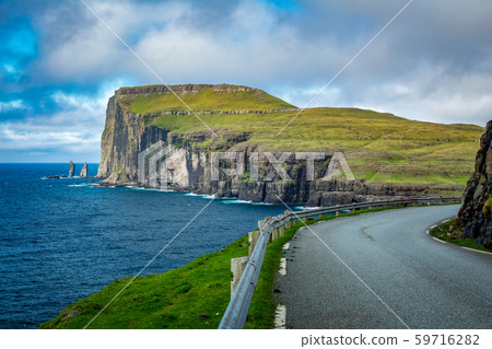 Road and The Giant and the Wich in northern coast of Eysturoy in Faroe Islands. Road and The Giant and the Wich in northern coast of Eysturoy in Faroe Islands. 59716282