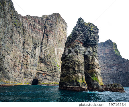 Wild rock formations in Faroe islands coastline Wild rock formations in Faroe islands coastline 59716284