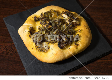 Homemade cebularz, Traditional Polish pancake with onion and common poppy seeds, from Jewish tradition, baked in Lublin, Poland. 59716720
