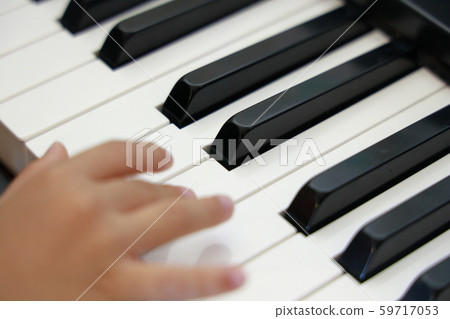 Child's hand playing the piano (4 years old) 59717053