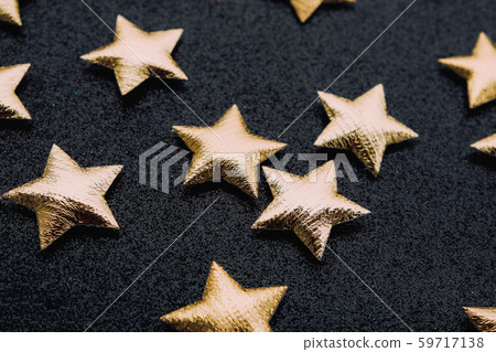 Golden stars on sparkly shining black festive background. 59717138