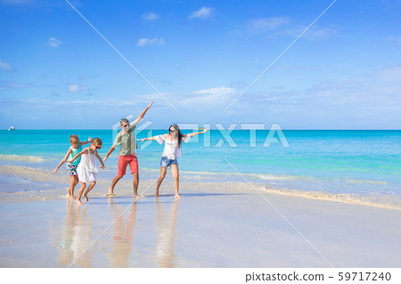 Happy beautiful family of four on the beach 59717240