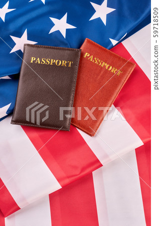 Two passports lying on American flag. Two passports lying on American flag. 59718509