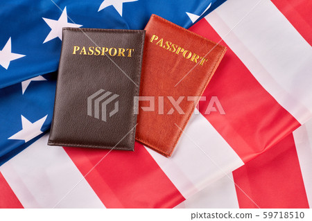 Close up two passports on American flag. Close up two passports on American flag. 59718510