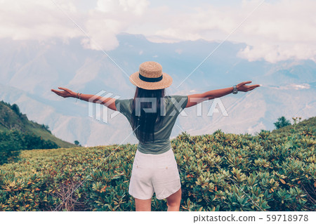 Beautiful happy young woman in mountains in the background of fog Beautiful happy young woman in mountains in the background of fog 59718978