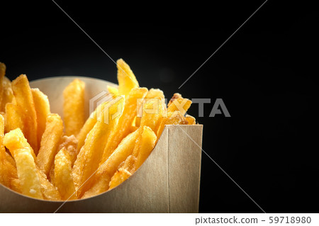 French fries in a paper basket. Fast food.French fries in a paper box on black background French fries in a paper basket. Fast food.French fries in a paper box on black background 59718980