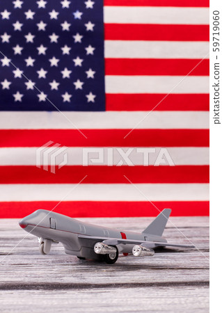 Toy passenger jet plane on USA background. 59719060