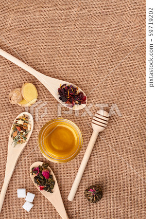 Tea leaves and honey on sackcloth, top view. Tea leaves and honey on sackcloth, top view. 59719202