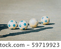 4 soccer balls on the soil ground 59719923